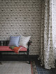 Bench in a thoughtfully curated space with 'Set the Scene' printed fabric from the Fogo Island Collection featured on the walls. The fabric, designed to reflect the cultural heritage of Newfoundland, adds depth and texture to the room. Photography by Chris Horwood.